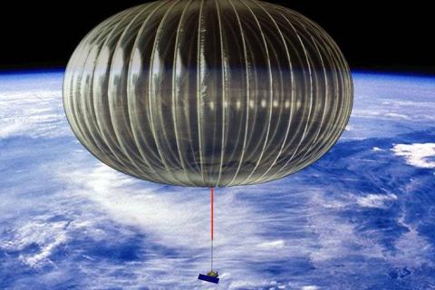 A scientific balloon is inflated carrying a small box in the upper atmosphere with the Earth way below. 
